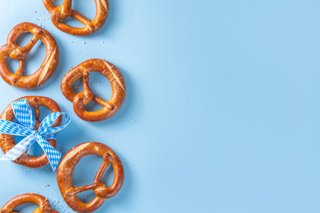 Oktoberfest background with bavarian pretzels and checkered ribbon tied with bow top view copy spaceの写真素材