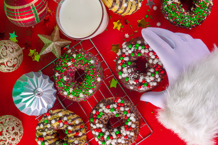 Bright festive decorated Christmas and New Year donuts set, with colorful red, green white snowflake sugar sprinkles. Sweet seasonal Christmas dessertの写真素材