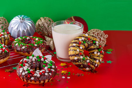 Bright festive decorated Christmas and New Year donuts set, with colorful red, green white snowflake sugar sprinkles. Sweet seasonal Christmas dessertの写真素材