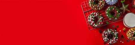 Bright festive decorated Christmas and New Year donuts set, with colorful red, green white snowflake sugar sprinkles. Sweet seasonal Christmas dessertの写真素材