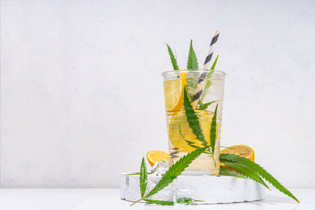 Cannabis hemp cold lemonade drink, Alternative cold mojito lemon drink with marijuana extract and leaves, legal industrial hemp use concept. CBD infused fruit waterの写真素材