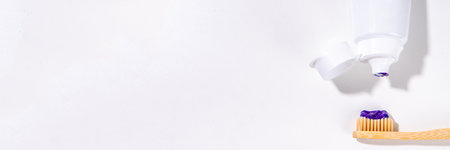 Trendy whitening purple Toothpaste, korean asian toothpaste with toothbrush and white unrecognizable tooth cleaning paste tube copy spaceの写真素材