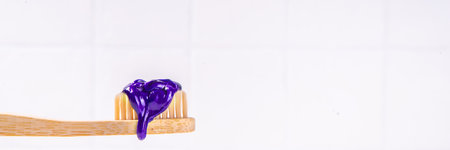 Trendy whitening purple Toothpaste, korean asian toothpaste with toothbrush and white unrecognizable...
