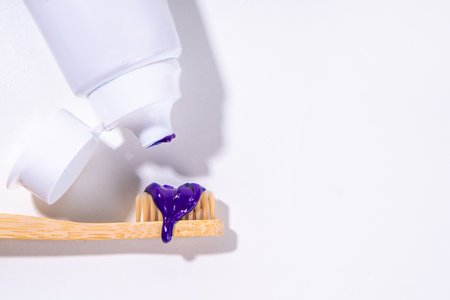 Trendy whitening purple Toothpaste, korean asian toothpaste with toothbrush and white unrecognizable tooth cleaning paste tube copy spaceの写真素材