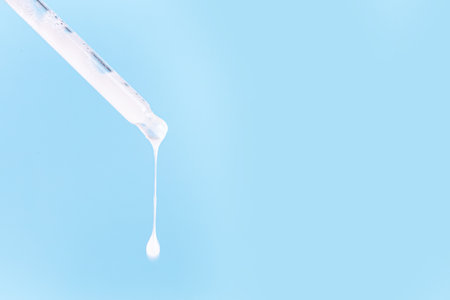 Ceramide barrier serum mockup. A bottle with ceramide or peptide milky white serum, with pipette for...