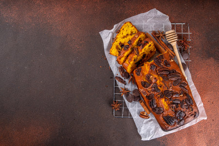 Homemade pecan and chocolate pumpkin  bread. Sliced loaded sweet dessert pumpkin bread, with nutsand...