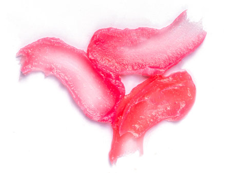 Set with make up cosmetics swatches ipstick, lip gloss on white background, top view  Decorative...