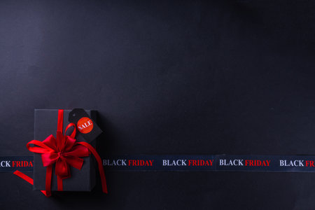 Black friday shopping and day background, Black Friday advertisement, sale promotion invitation with black red gift boxes, laptop, shop tags, crossed sale ribbons, copy space
