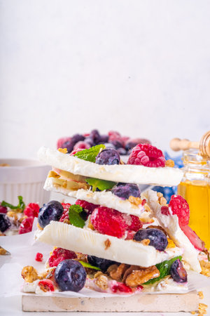 Homemade frozen Yogurt Bark, alternative healthy keto diet ice cream made from greek yogurt, fresh berries, nuts, granola, honey, on baking tray deco. Frozen yoghurt bars with fruit berry toppingsの写真素材