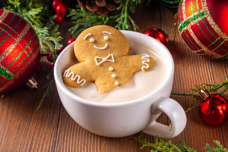 Funny cute gingerbread man in a hot chocolate, cappuccino or latte. Festive Christmas cocoa mug with...