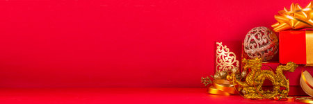 Chinese New Year 2024 greeting card. Bright red asian year of the dragon background with golden dragon figurine, Chinese lanterns, traditional jewelry, gifts, coins, cookies with wishes, copy spaceの写真素材
