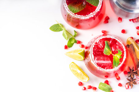 Pomegranate mocktail or cocktail, Boozy alcohol pomegranate and lime drink, lemonade, mojito, margarita with frozen rimの写真素材