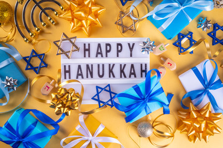 Happy Hanukkah greeting card background. Jewish New Year holiday flat lay with traditional symbols of hanukkah festival, menorah, donuts and decorations copy spaceの写真素材