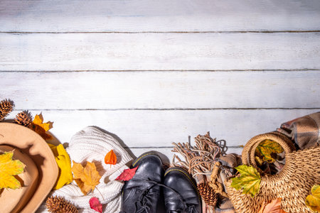 Preparation for fall and winter season, autumn cozy clothes and decor background, wooden table top...
