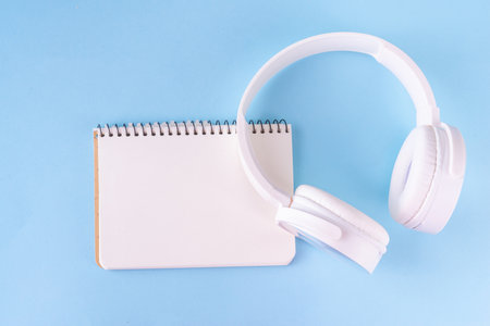 Sound Therapy Mental Health and Wellness concept. Light blue background with laptop and headphones top view flat lay copy spaceの写真素材