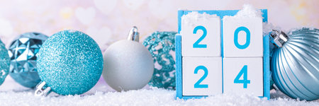 Christmas New Year background with wooden calendar 2024, with holiday decorations and artificial snow, copy spaceの写真素材