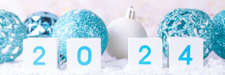 Christmas New Year background with wooden calendar 2024, with holiday decorations and artificial snow, copy spaceの写真素材