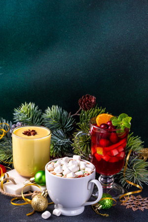 Set of traditional Christmas winter drinks. Christmas bar menu background.Tree cup with mulled wine, eggnog, hot chocolate beverages om dark background with Christmas, New Year decoration copy spaceの写真素材