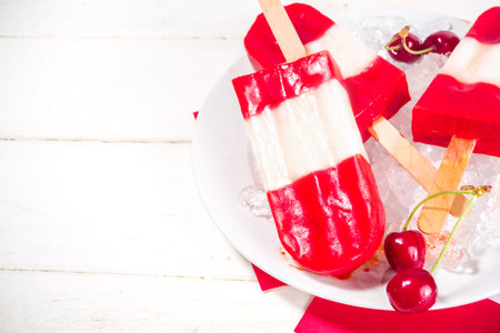 Patriotic Red White Ice cream Popsicles for Canada Day, on white wooden table. Copy space top viewの写真素材