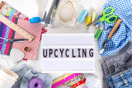 DIY upcycling ideas and materials background. Sustainable hobby with handmade, ecology creative reusable hand made with plastic bottles, metal cans, old jeans, fabrics, glass containers, top viewの写真素材