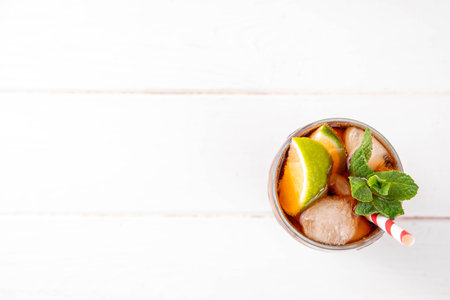 Cuba Libre or long island iced tea cocktail with strong drinks, cola, lime and ice in glass, cold long drink or lemonadeの写真素材