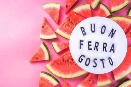 Buon Ferragosto (Happy Ferragosto) greeting card, holiday background, Italian harvest festival August 15, with lightbox text Buon Ferragosto, watermelon, summer accessories top view copy spaceの写真素材