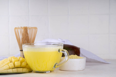 Yellow matcha drink. Mango matcha extract tea or latte, fruity healthy beverage on white background copy spaceの写真素材