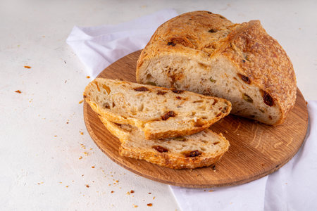Homemade freshly baked sourdough bread. Craft homemade baked bread, rye and white, on a white table....