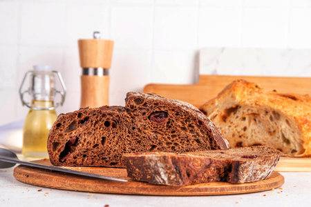 Homemade freshly baked sourdough bread. Craft homemade baked bread, rye and white, on a white table....