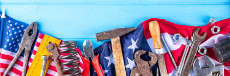 American National Patriotic Workers Happy Labor day Holiday background. Construction and manufacturing tools on wooden background with stars, red white blue striped US flagの写真素材