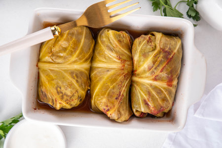Homemade Stuffed cabbage rolls on white table. Cabbage rolls with meat or vegetables with rice, balanced healthy food recipeの写真素材