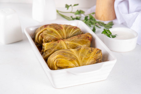 Homemade Stuffed cabbage rolls on white table. Cabbage rolls with meat or vegetables with rice, balanced healthy food recipeの写真素材