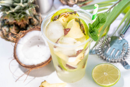 Pineapple coconut lemonade mojito drink, summer iced cocktail, mocktail with fresh fruit and juices
