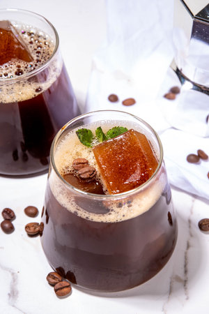 Cold Brew Coffee Espresso Carajillo Cocktail with frozen espresso ice cubes, strong black coffee,...