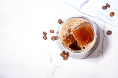 Cold Brew Coffee Espresso Carajillo Cocktail with frozen espresso ice cubes, strong black coffee, liqueur and Vodka, on white kitchen table background copy spaceの写真素材