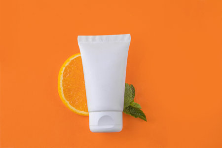 Orange citrus Vitamin C face care - cream, serum. mask, face cleaner, antioxidant moisturizer skin face care and make up concept, with fresh orange fruit slicesの写真素材