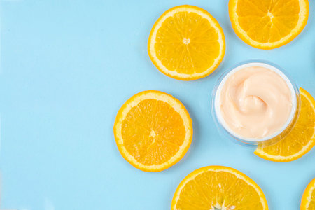 Orange citrus Vitamin C face care - cream, serum. mask, face cleaner, antioxidant moisturizer skin face care and make up concept, with fresh orange fruit slicesの写真素材