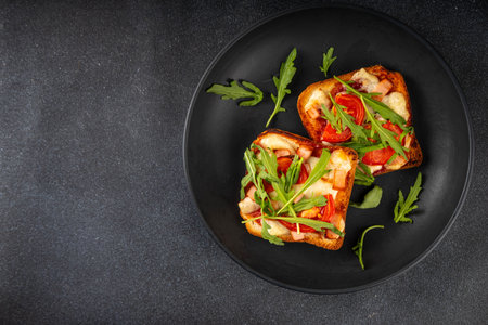 Tasty crunchy toasts pizza. Fast food, modern variation of portioned quick made pizza on toast bread with tomato, bacon, mozzarella cheese and arugula, copy spaceの写真素材