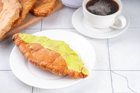 Set of colorful trendy flat croissants with different topping and fillings. Flat vanilla, pistachio, chocolate croissant, modern baked sweet dessert pastryの写真素材
