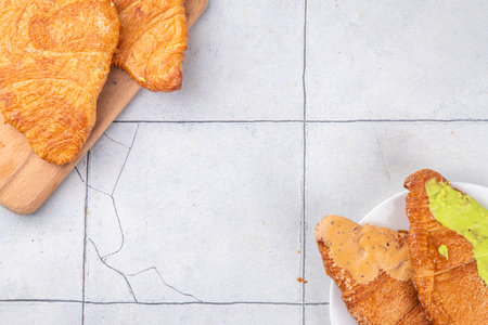 Set of colorful trendy flat croissants with different topping and fillings. Flat vanilla, pistachio,...