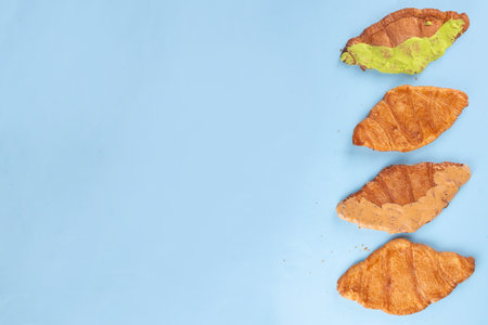 Set of colorful trendy flat croissants with different topping and fillings. Flat vanilla, pistachio,...