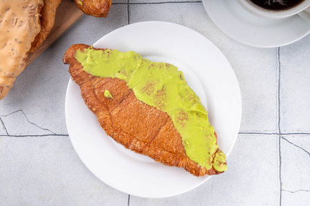 Set of colorful trendy flat croissants with different topping and fillings. Flat vanilla, pistachio,...