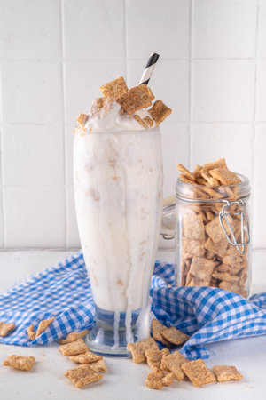 Cinnamon Toast Crunch cold milkshake drink with cinnamon sugar and caramel, glass of iced dairy...