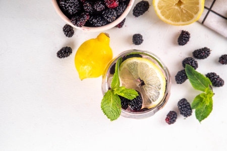 Mulberry lemonade or mojito cocktail, cold iced refreshing summer drink with lemon, mint and a lot...