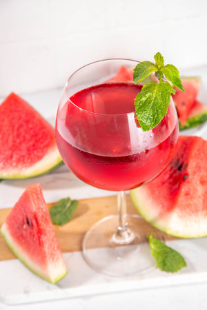 Homemade sweet cold watermelon wine glass with slices of ripe fresh red watermelon and mint leavesの写真素材
