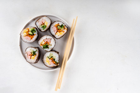 Gimbap or kimbap, korean rolls, traditional dish. Homemade kimbap roll with ham, vegetables and lettuceの写真素材