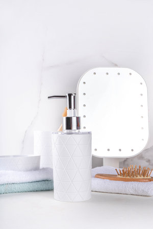 Bathroom shelf simple white background. Dispenser for soap, shower gel, soap dish, glass with...