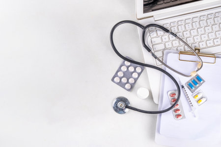 Simple medical healthcare background with notebook, clipboard, stethoscope, syringe and pills, Doctors, tests, health care, annual vaccination background top view copy spaceの写真素材