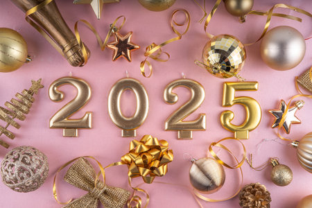 Merry Christmas and Happy New Year 2025 background with golden bauble, Christmas tree balls and decorations, gift bow, serpentine, 2025 golden candles numbers, flat lay top view copy spaceの写真素材