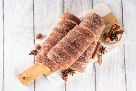 Traditional East Europe Christmas sugar glazed dessert chimney cake, trdlo or trdelnik, sweet...